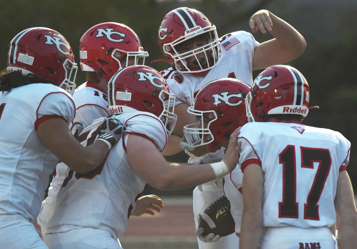 New Canaan celebrates one of Hunter Telesco's four touchdowns during a football game against Xavier in Middletown on Friday, Sept. 9, 2022.