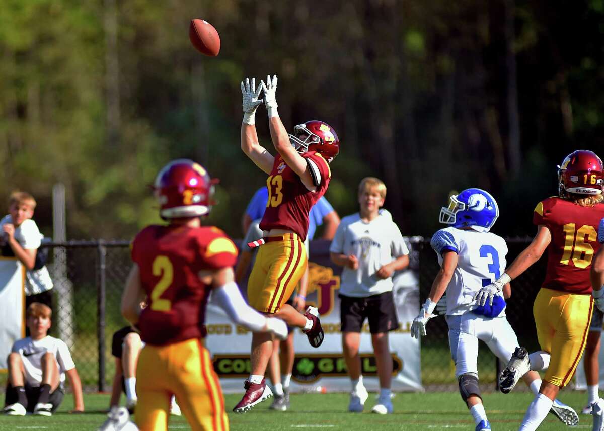 A Darien pass intended for Isaac McMullin (3), at right, is intercepted by St. Joseph's Sam Rosa (13) during football action in Trumbull, Conn., on Saturday September 10, 2022.
