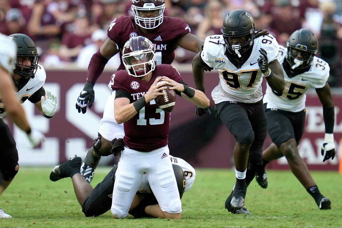 Texas A&M quarterback Haynes King is tackled by Appalachian State linebacker Nick Hampton during the first half Saturday.