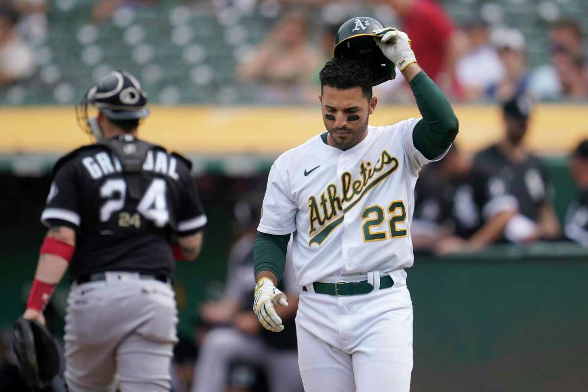 Oakland Athletics' Ramon Laureano, left, is tagged out by Houston