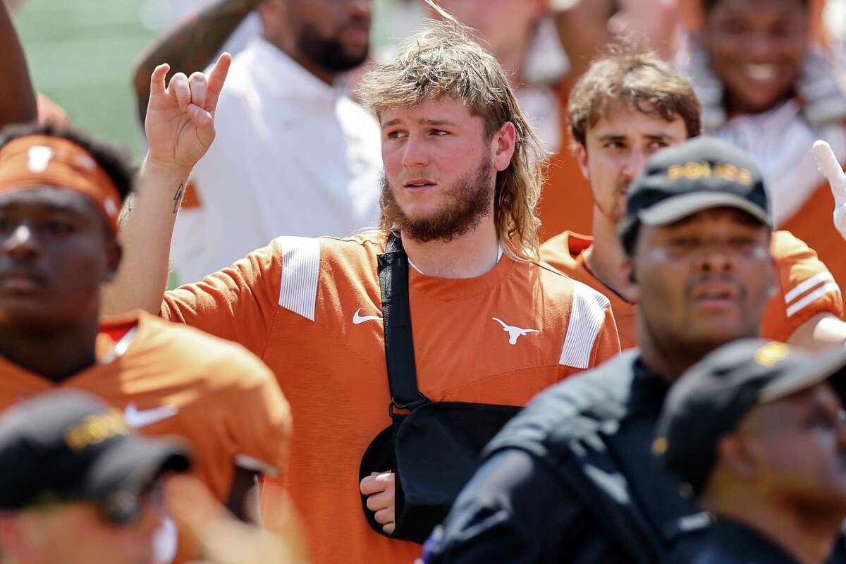 Quinn Ewers (3) of the Texas Longhorns sings “The Eyes of Texas” while wearing a sling on his left arm after the game against the Alabama Crimson Tide at Darrell K Royal-Texas Memorial Stadium on September 10, 2022 in Austin, Texas.