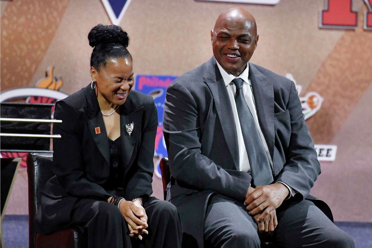 Presenters Dawn Staley and Charles Barkley laugh as they listen to Lindsay Whalen address a gathering during her enshrinement ceremony for the Basketball Hall of Fame, Saturday, Sept. 10, 2022, in Springfield, Mass.