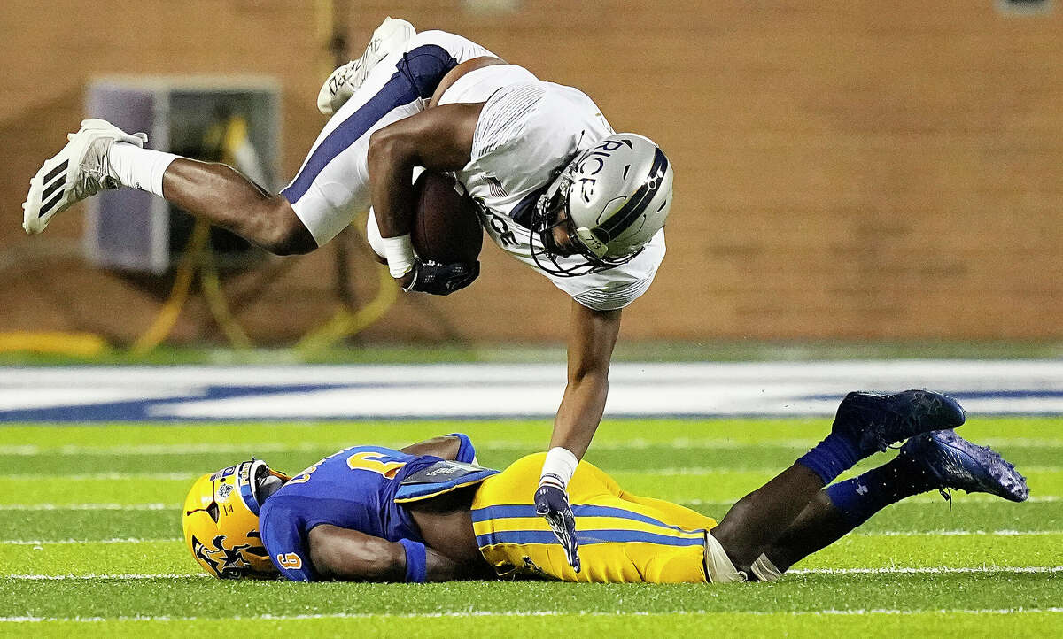 Rice Owls fullback Micah Barnett (49) is upended by McNeese State Cowboys safety Tyler Barnes (6) on a seven yard catch and run in the third quarter of a football game Saturday, Sept. 10, 2022, in Houston.