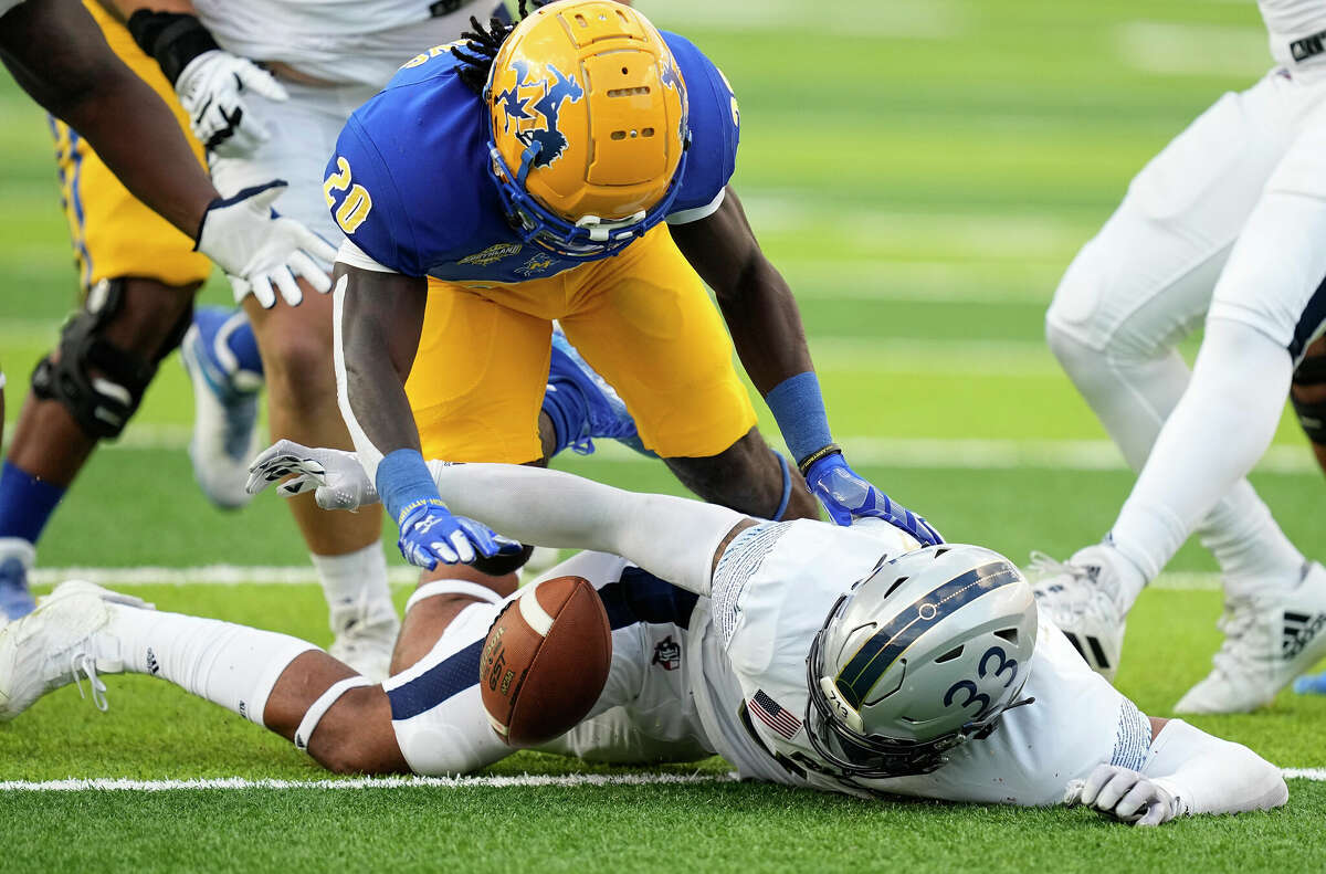 Rice Owls linebacker Myron Morrison (33) beats McNeese State Cowboys running back Deonta McMahon (20) to recover a fumble by quarterback Knox Kadum (10) in the first quarter of a football game Saturday, Sept. 10, 2022, in Houston.