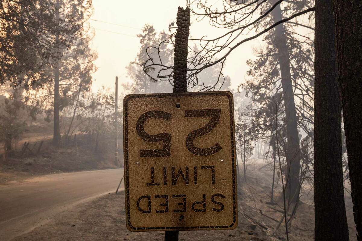 A burnt out road sign is seen near Michigan Bluff during the Mosquito Fire in unincorporated Placer County, Calif. Thursday, Sept. 8, 2022.(Stephen Lam/San Francisco Chronicle via AP)