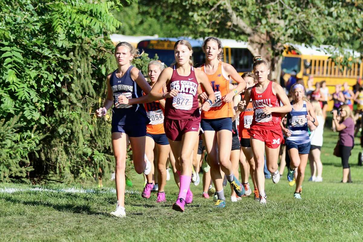 Father McGivney's Elena Rybak, left, leads a pack of runners at the First to the Finish Invitational on Saturday at Detweiller Park in Peoria.