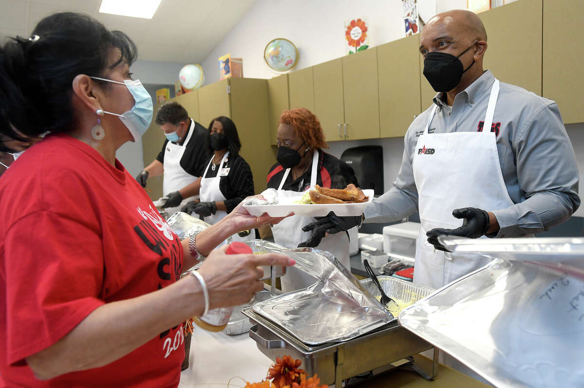 Port Arthur ISD Superintendent Mark Porterie jokes with staff as he serves up cheesy grits as he and fellow school board members held a thank you breakfast for teachers and staff at the Phillis Wheatley School of Early Childhood Friday. The board is serving breakfast to each of its A and B graded campuses as a way of expressing gratitude for their hard work and achievement. Photo made Friday, September 9, 2022 Kim Brent/Beaumont Enterprise