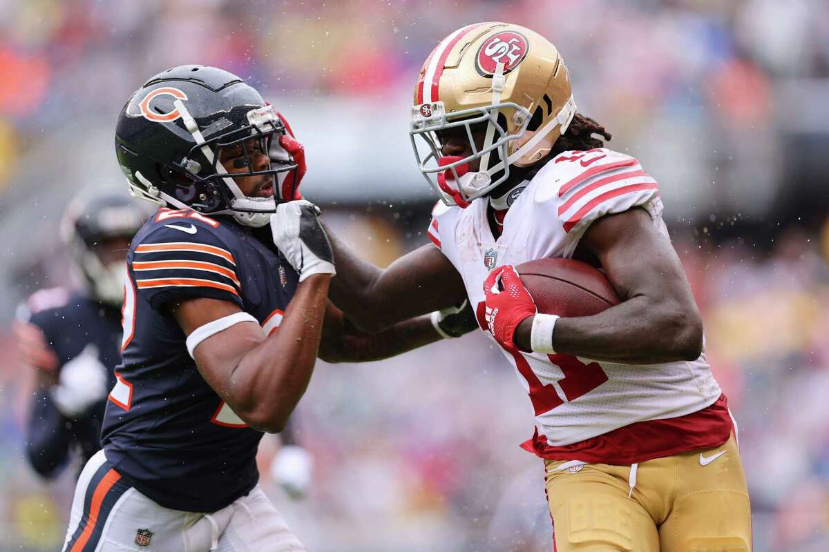 CHICAGO, ILLINOIS - SEPTEMBER 11: Wide receiver Brandon Aiyuk #11 of the San Francisco 49ers stiff arms cornerback Kindle Vildor #22 of the Chicago Bears during the first half at Soldier Field on September 11, 2022 in Chicago, Illinois.