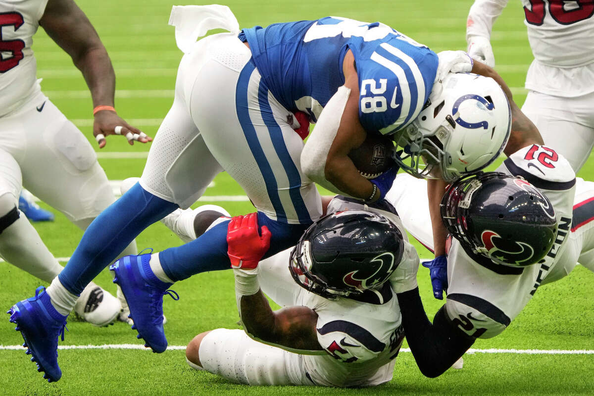 Houston Texans linebacker Kamu Grugier-Hill (51) and cornerback Steven Nelson (21) stop Indianapolis Colts running back Jonathan Taylor (28) during the second half of an NFL football game Sunday, Sept. 11, 2022, in Houston.
