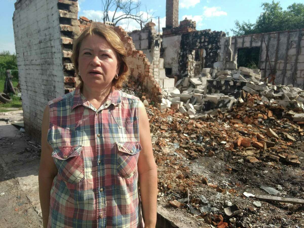 Anna Bakumenko stands outside her destroyed home in a village near Chernihiv in northern Ukraine. She and her husband fled to western Ukraine when the war began. They returned after Russian forces withdrew in the spring.