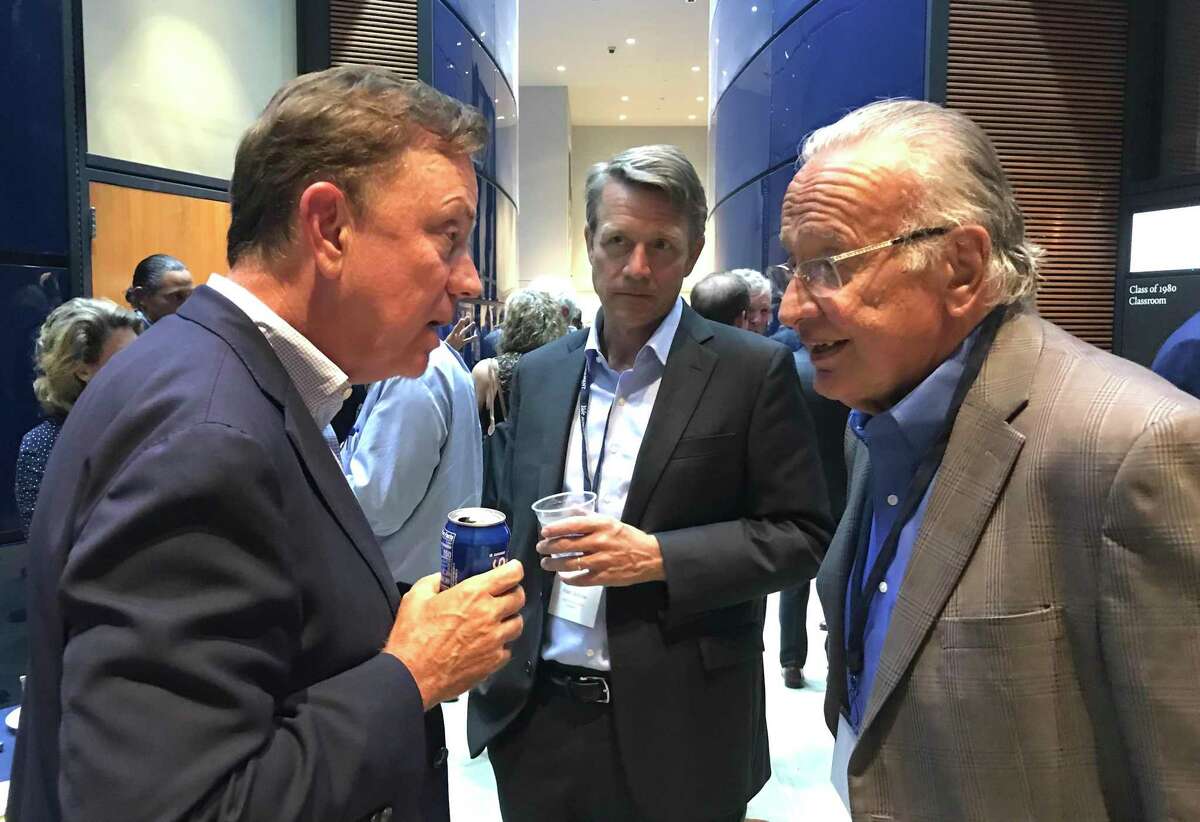 Key business executives and political, civic, nonprofit and academic leaders from Connecticut gathered Sept. 7 at the Yale School of Management, convened by Jeffrey Sonnenfeld, to discuss the state’s economy. Gov. Ned Lamontl left, is shown talking with Robert Patricelli, a retired health care executive and moderate Republican wo has contributed to Lamont. At center is Peter Denious, CEO of AdvanceCT, an economic development agency.
