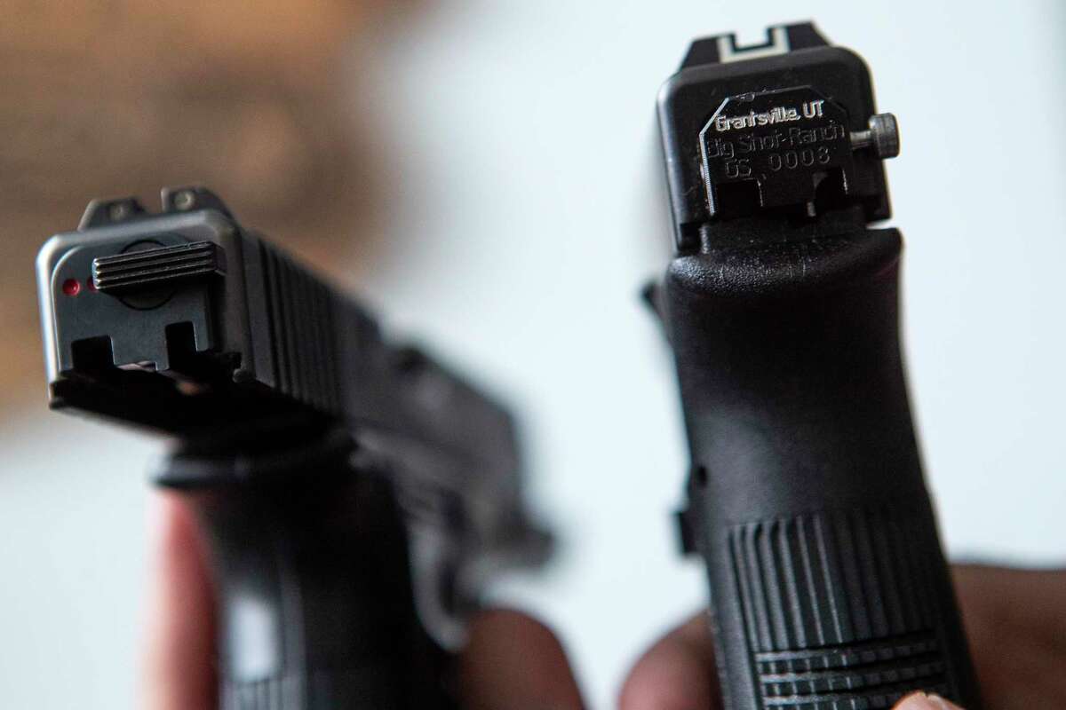 Glock switches are shown installed on a pair of handguns Wednesday, Feb. 23, 2022 in Houston.
