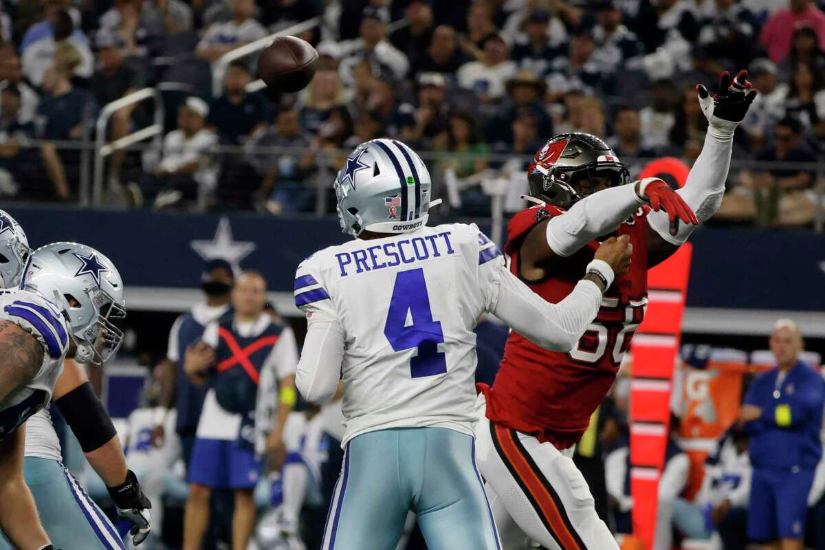 Dallas Cowboys quarterback Dak Prescott (4) is hit by Tampa Bay Buccaneers linebacker Shaquil Barrett (58) after throwing a pass in the second half of a NFL football game in Arlington, Texas, Sunday, Sept. 11, 2022. 