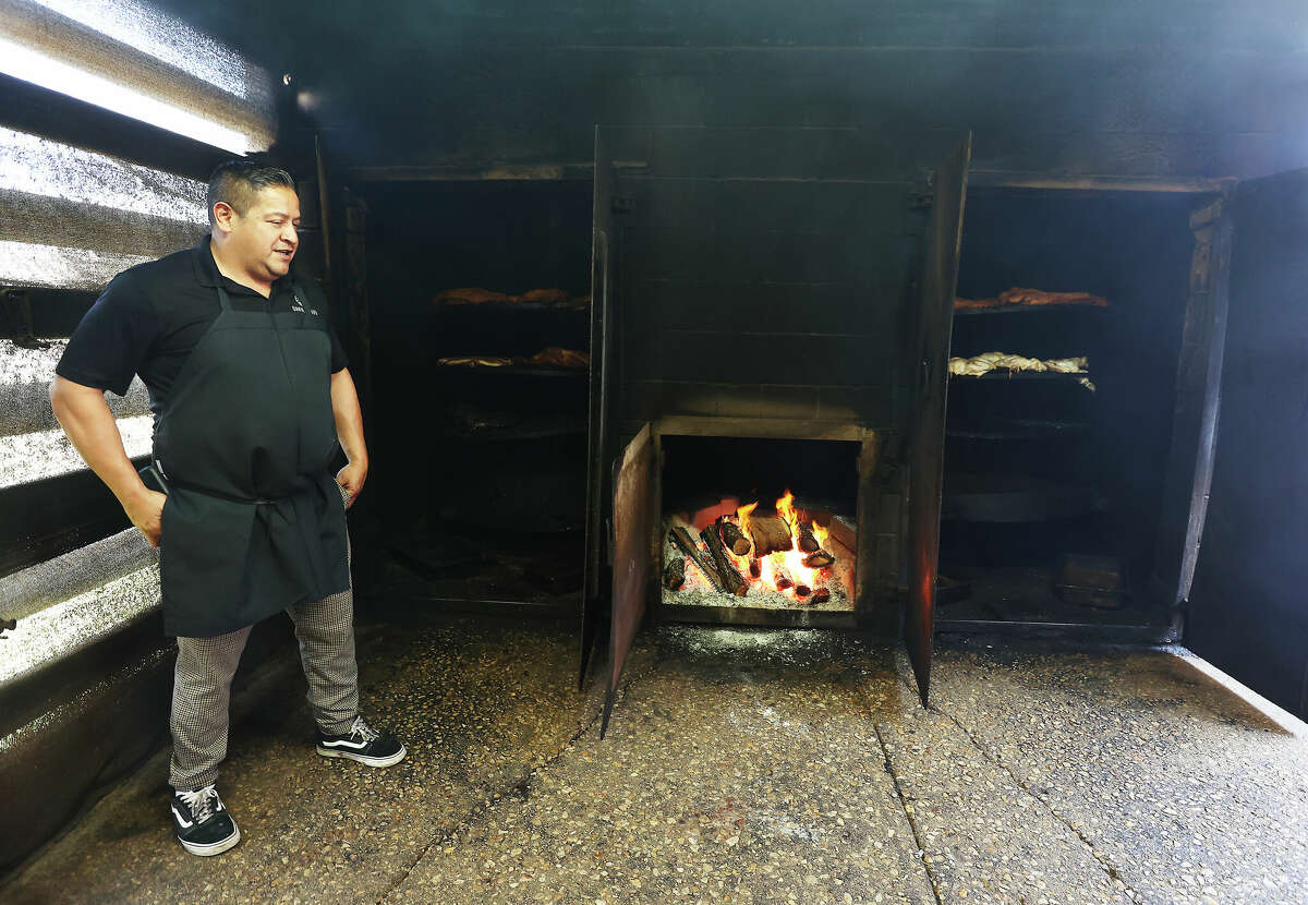 Adrian Davila of Davila's BBQ in Seguin shows off his wood-fired smoke pit.