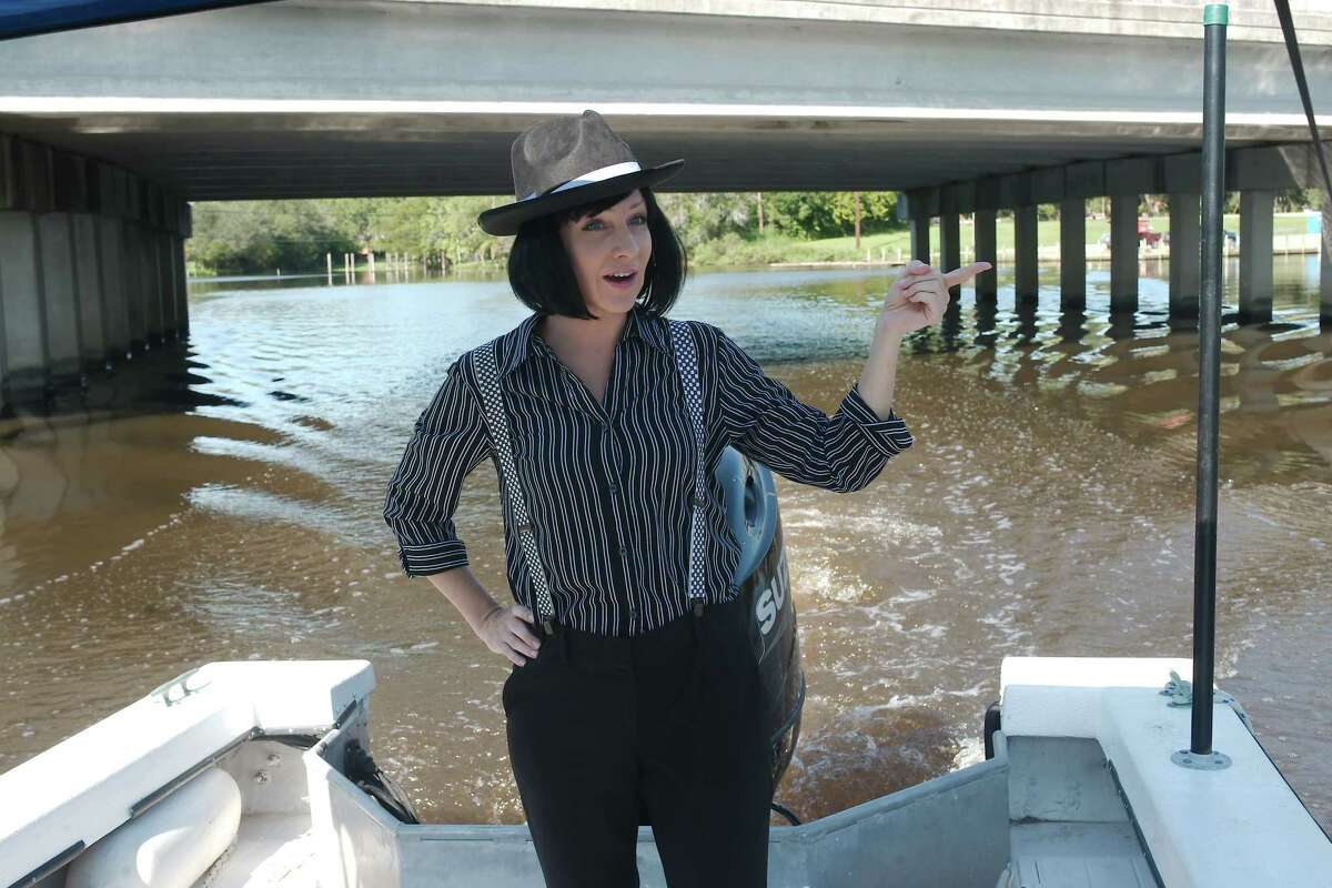 “Ghost Tour on the Bayou” guide January Leigh points out sites as the tour boat passes under a railroad trestle over Dickinson Bayou.