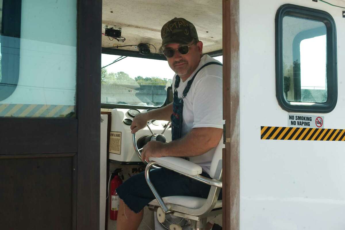 Captain "P. Rowe" Douglas Dunn guides the “Ghost Tour on the Bayou” boat along Dickinson Bayou. 