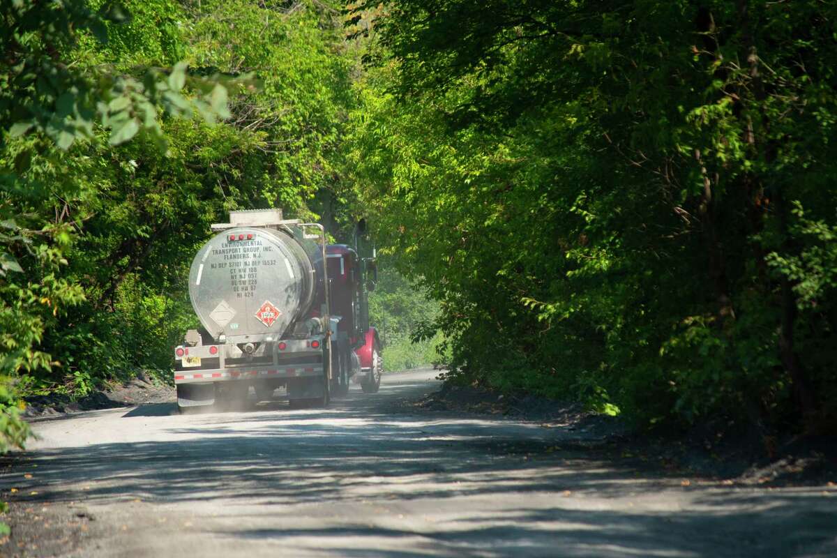A semi-trailer tanker truck is driven down the dirt road that all trucks need to use to enter the Norlite plant on Monday, Aug. 29, 2022, in Colonie, N.Y. (Paul Buckowski/Times Union)