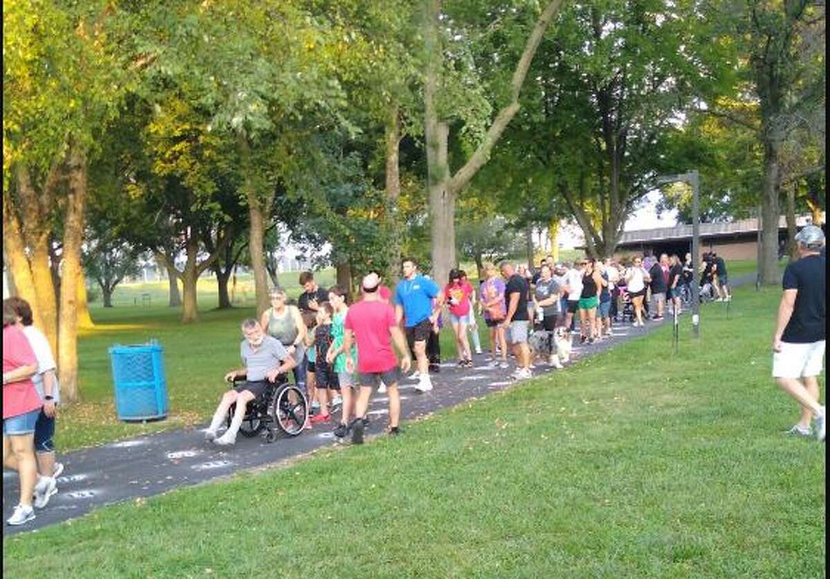 More than 120 people gathered in Roxana Park Saturday night to participate in the Out of the Darkness community walk
