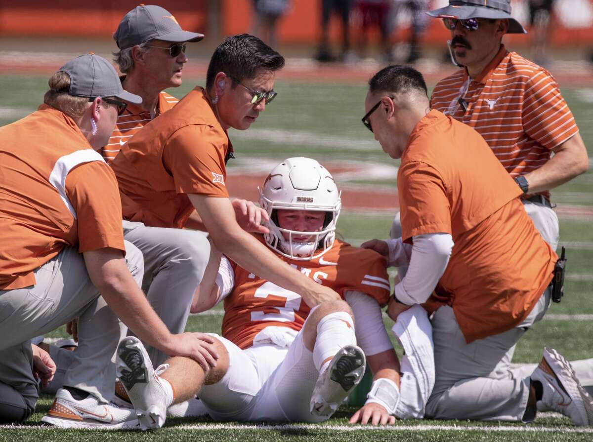 Texas quarterback Quinn Ewers (3) is helped up off the ground after a hit and personal foul by Alabama linebacker Dallas Turner during the first half of an NCAA college football game, Saturday, Sept. 10, 2022, in Austin, Texas. Texas' Ewers was injured on the play leaving the game. Ewers did not return to the game. (AP Photo/Rodolfo Gonzalez)