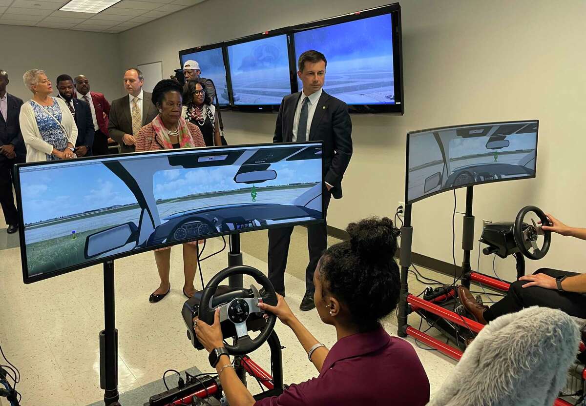 Transportation Secretary Pete Buttigieg and U.S. Rep. Sheila Jackson-Lee, D-Houston, watch a flight simulation by Texas Southern University students during a tour of the school’s aviation program on Sept. 12, 2022.