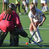 Staples' Francine Stevens (11) closes in on the gcage while New Canaan goalie Emma Rosen defends during a field hockey game in Westport on Monday, Sept. 12, 2022.