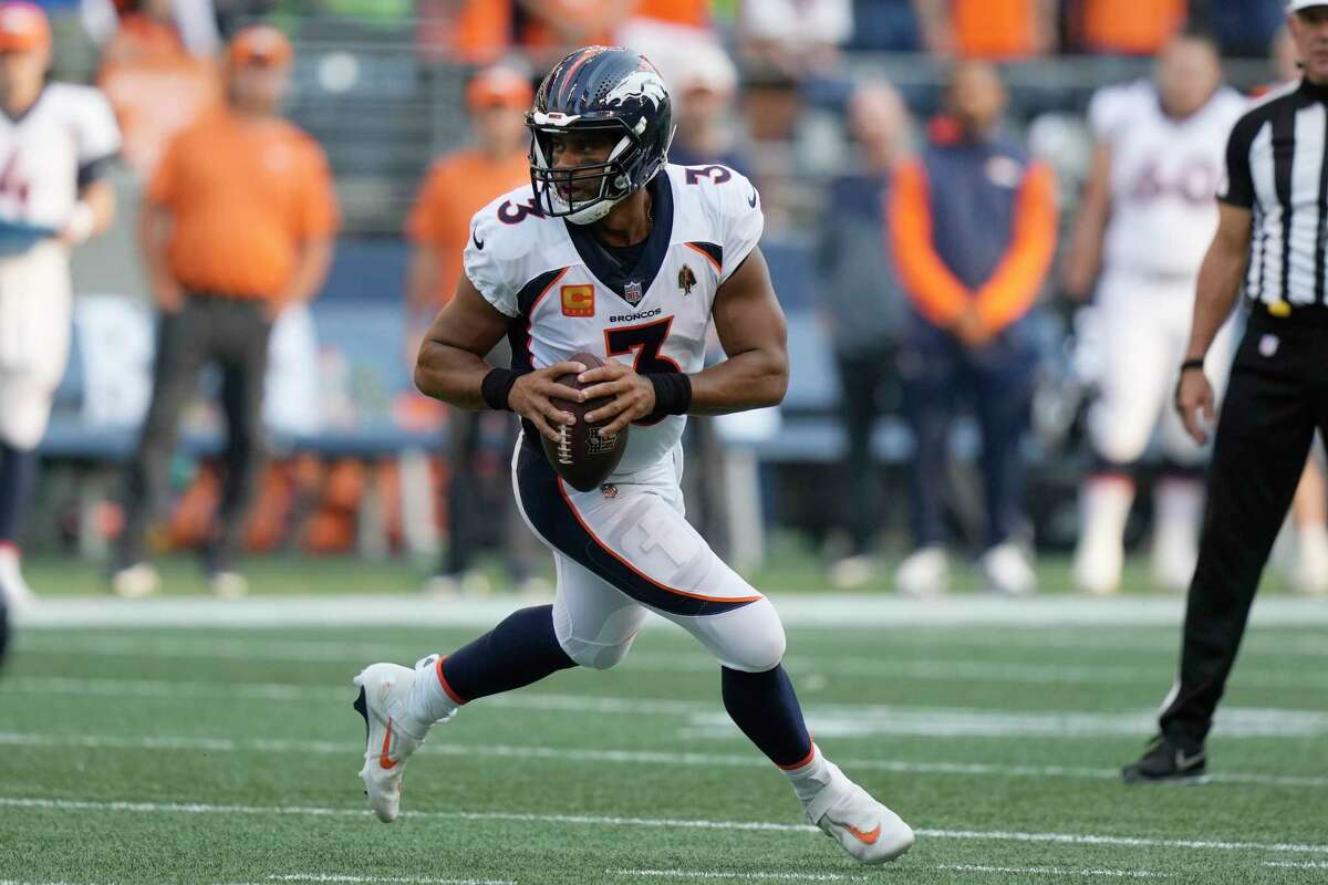 Denver Broncos quarterback Russell Wilson drops to pass against the Seattle Seahawks during the first half of an NFL football game, Monday, Sept. 12, 2022, in Seattle.