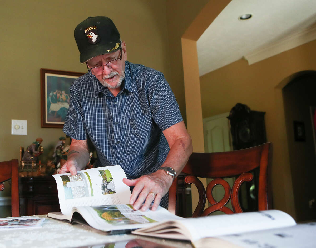 Vietnam veteran Edward Pye shows a book of Vietnam War memorials at his home, Friday, Sept. 9, 2022, in Conroe. Pye, who was a paratrooper with the 101st Airborne Division, will take part in the upcoming flight to Washington D.C. with Honor Flight Houston, which flies veterans to the capitol to visit war memorials.