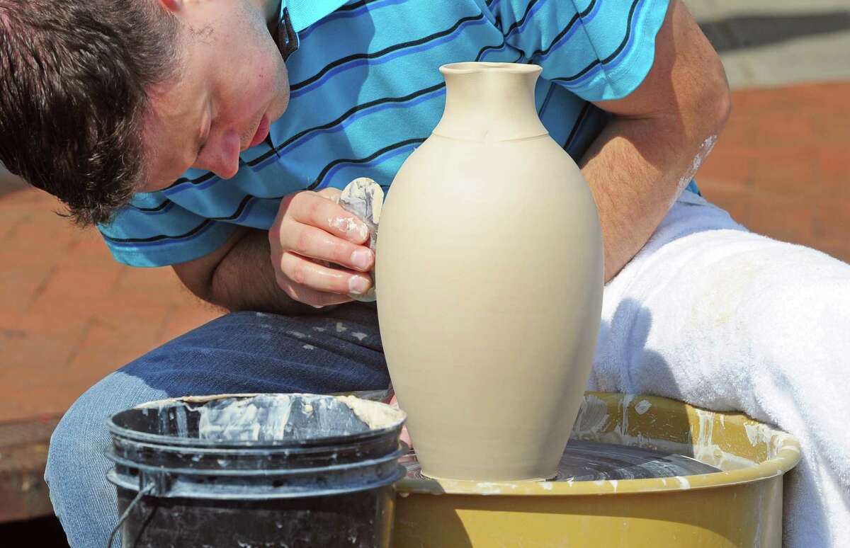 Jon Puzzuoli, of Norwalk, creates a vase in front of his tent, during the annual Arts & Crafts on Bedford event on Bedford Street in downtown Stamford, Conn., on Saturday September 10, 2022. Arts & Crafts on Bedford brings juried artisans from throughout the Northeast who will display and sell juried works including ceramics, fiber arts, fine art, jewelry, metal, photography, painting, wood and more. Arts & Crafts on Bedford is presented by Stamford Downtown Special Services District and sponsored by 95.9 The Fox, Star 99.9, WEBE 108 and Happyhaha.com Photography.