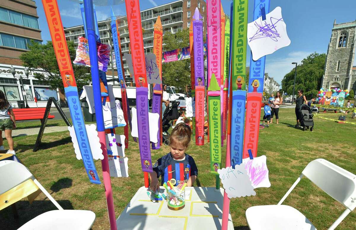 Alessandra Borrajo, 2, draws at the Lil' Canvas Kids station at Latham Park during the annual Arts & Crafts on Bedford event on Bedford Street in downtown Stamford, Conn., on Saturday September 10, 2022. Arts & Crafts on Bedford brings juried artisans from throughout the Northeast who will display and sell juried works including ceramics, fiber arts, fine art, jewelry, metal, photography, painting, wood and more. Arts & Crafts on Bedford is presented by Stamford Downtown Special Services District and sponsored by 95.9 The Fox, Star 99.9, WEBE 108 and Happyhaha.com Photography.