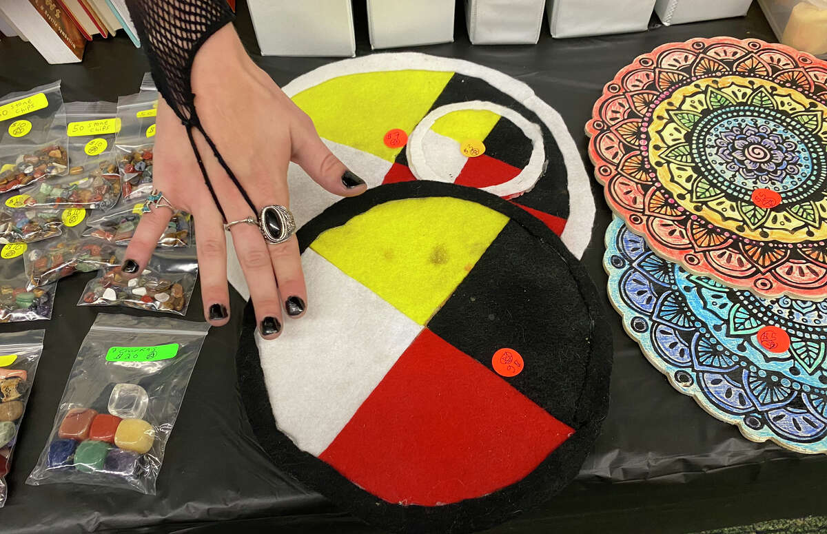 Wiccan Amber Furtah shows off some of the shamanic medicine wheels on her vendor's table at the Bad Axe Psychic Fair held at Lisa's Love Boutique on Sept. 10.