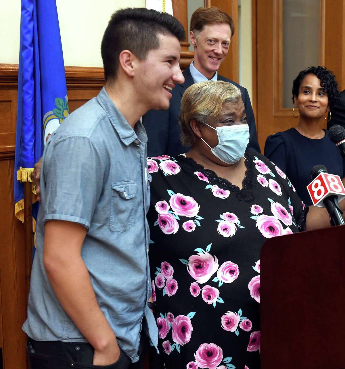 Tenant organizer Luke Melonakos-Harris, left, translates for Quinnipiac Gardens Tenant Union member Mercedes Ramos, center, during a news conference before Mayor Justin Elicker signed a tenants union ordinance at City Hall in New Haven on September 13, 2022.