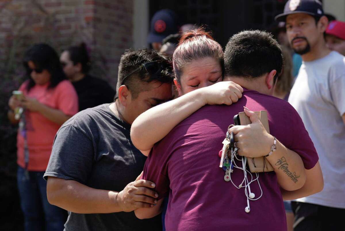 Francisco Madrid, right, a ninth-grader at Heights High School, is reunited with his mother, Adriana Ordaz, and Vero Hernandez, left, Tuesday, Sept. 13, 2022, near Heights High School in Houston.