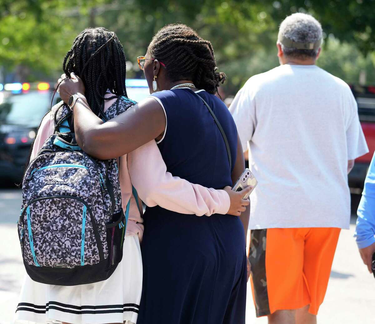 A woman hugs a student as they walked away from Heights High School after they were reunited after a reported active shooter scare at Heights High School on Tuesday, Sept. 13, 2022 in Houston. Active shooter scare forces Heights High School and nearby campuses into lockdown.