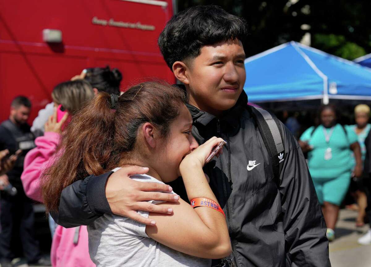 Heights High School Ninth Grade Student Juan Garcia comforts his mother, Erica Flores, after they are reunited at Arlington and E. 14th Streets Tuesday, Sept. 13, 2022, in Houston. An active shooter scare forces the school and nearby campuses into lockdown.
