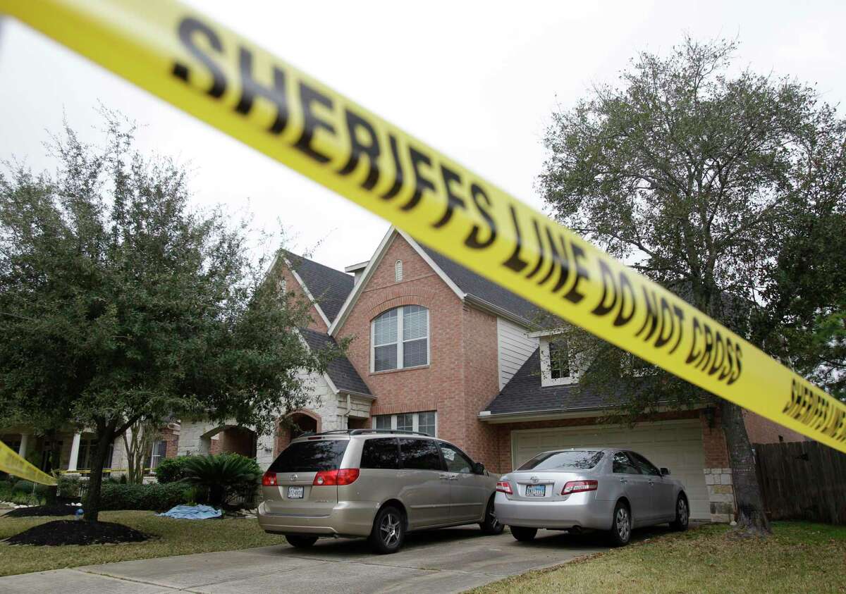Crime scene tape surrounds a home at 14015 Fosters Creek Dr. Friday, Jan. 31, 2014 in Cypress where four people where found dead inside on Thursday. ( Melissa Phillip / Houston Chronicle )