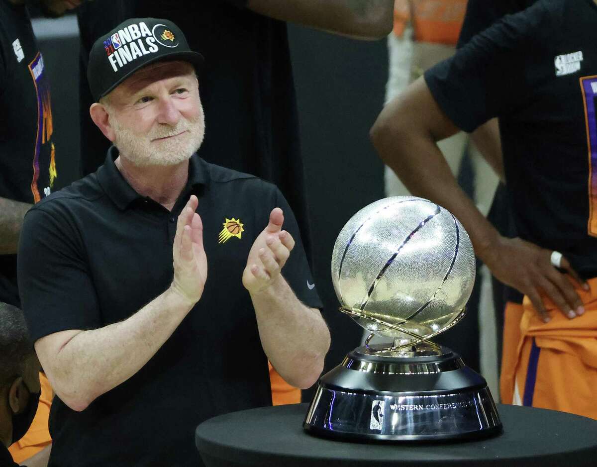 Phoenix Suns owner Robert Sarver — shown with the Western Conference Championship trophy after the Suns beat the Los Angeles Clippers in the Western Conference Finals on June 30, 2021 — has been suspended for a year and fined $10 million after an investigation found that he had engaged in “workplace misconduct and organizational deficiencies.”
