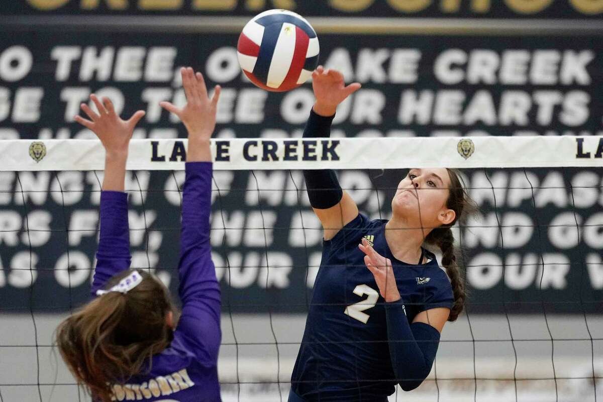 Lake Creek’s Ashlynn Kilgore, right, spikes the ball as Montgomery’s Abby Whitehead defends during a high school volleyball match, Tuesday, Sept. 13, 2022, in Montgomery, TX.