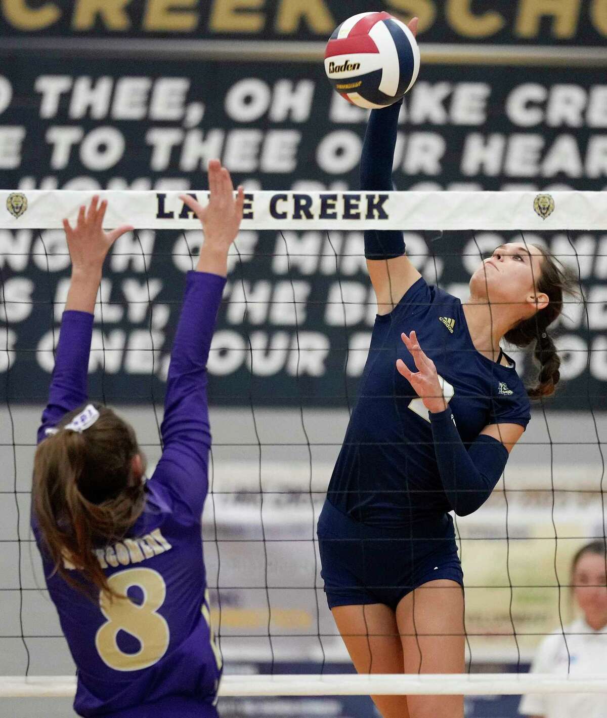 Lake Creek’s Ashlynn Kilgore, right, spikes the ball as Montgomery’s Abby Whitehead defends during a high school volleyball match, Tuesday, Sept. 13, 2022, in Montgomery, TX.