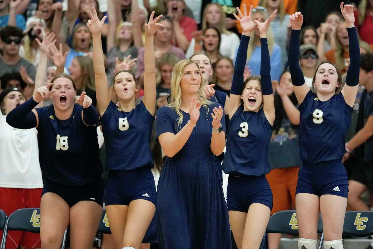 Lake Creek head coach Taryn Driver, center, celebrates a point with her team during a high school volleyball match against Montgomery, Tuesday, Sept. 13, 2022, in Montgomery, TX.