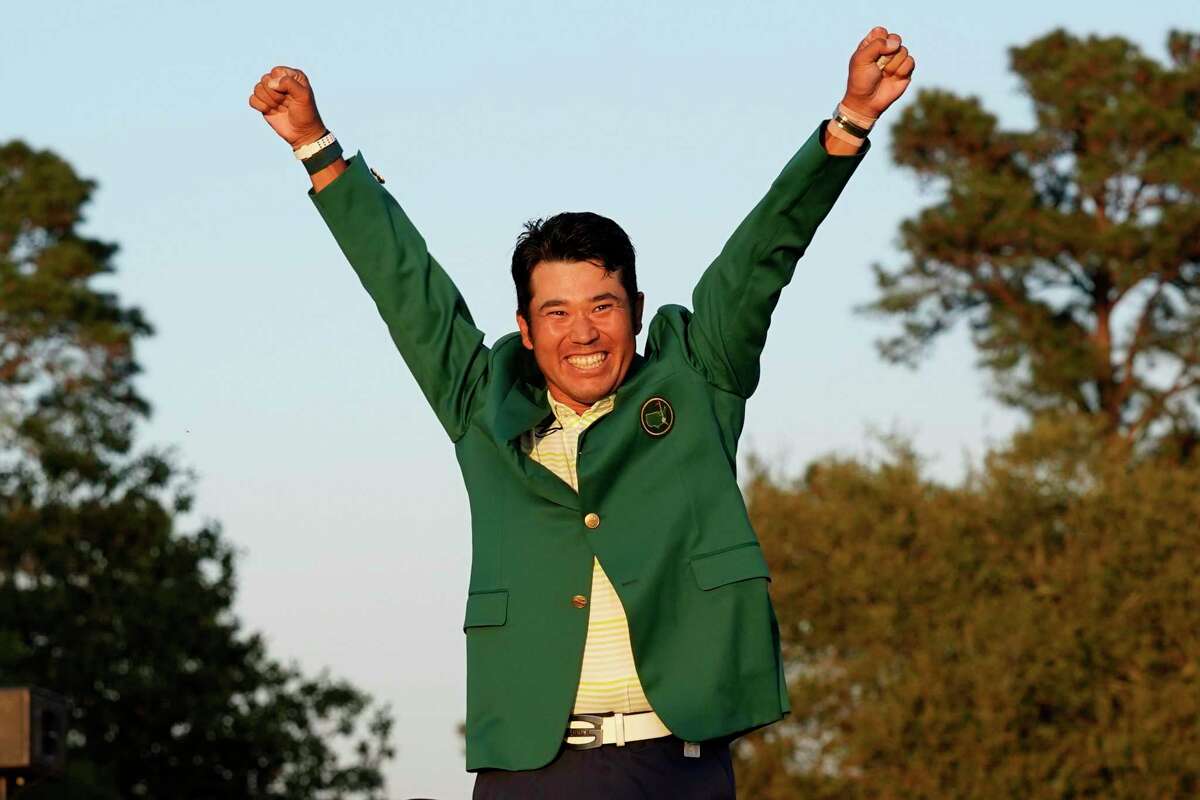 Hideki Matsuyama, of Japan, celebrates after putting on the champion's green jacket after winning the Masters golf tournament on Sunday, April 11, 2021, in Augusta, Ga. (AP Photo/Gregory Bull)