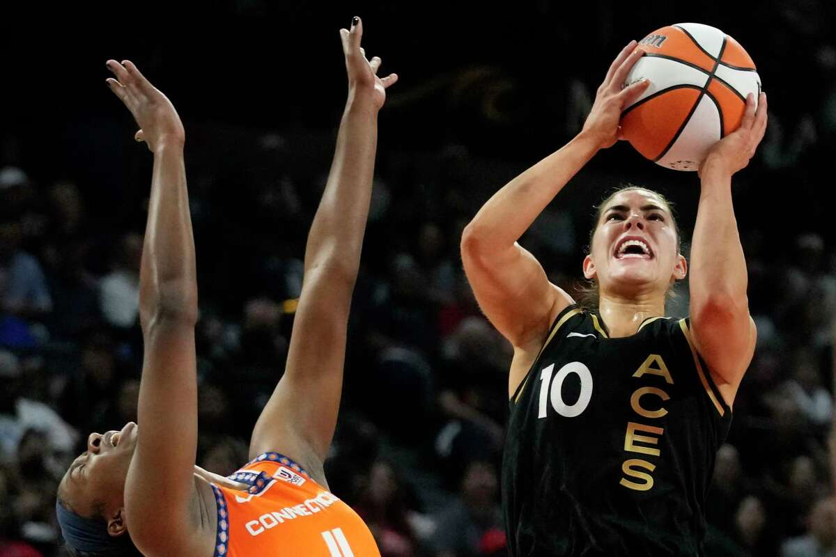 Las Vegas Aces guard Kelsey Plum (10) shoots over Connecticut Sun guard Nia Clouden (11) during the first half in Game 2 of a WNBA basketball final playoff series Tuesday, Sept. 13, 2022, in Las Vegas.