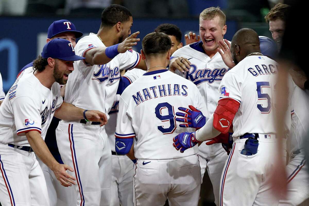 ARLINGTON, TEXAS - SEPTEMBER 13: Mark Mathias #9 of the Texas Rangers celebrates after hitting a walk-off home run against the Oakland Athletics in the bottom of the ninth inning at Globe Life Field on September 13, 2022 in Arlington, Texas. (Photo by Tom Pennington/Getty Images)