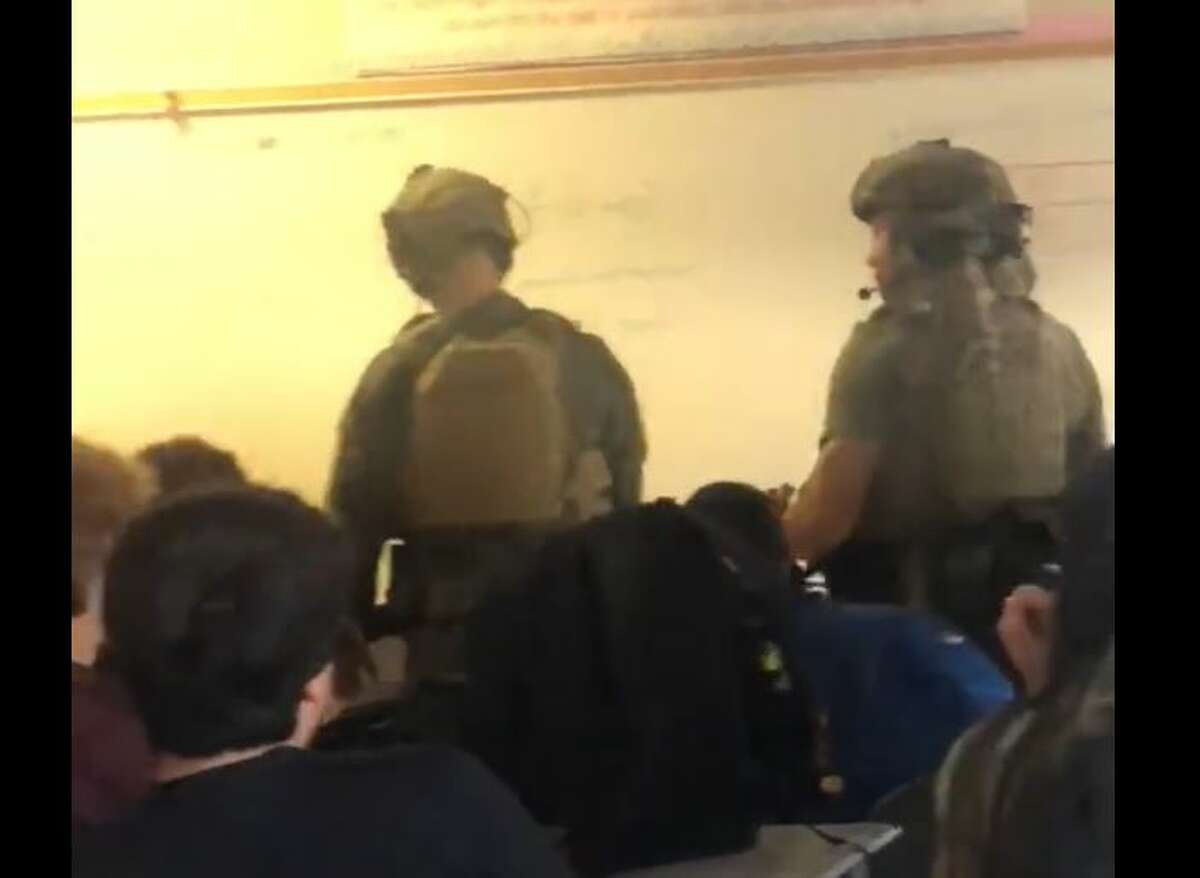 SWAT and police officers entered classrooms while investigating a school shooting at Heights High School in Houston. 