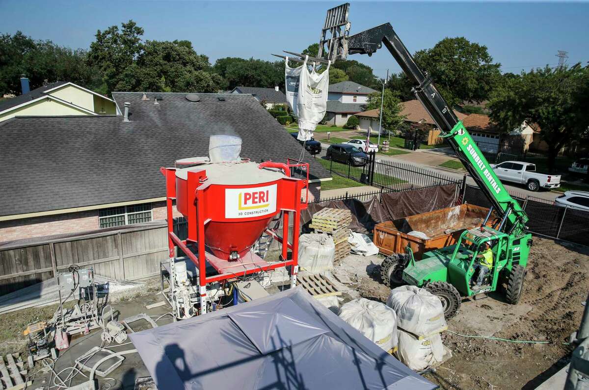 Quikrete concrete is constantly mixed as it's being 3D-printed in the construction of a new home in Spring Branch Valley in Houston.