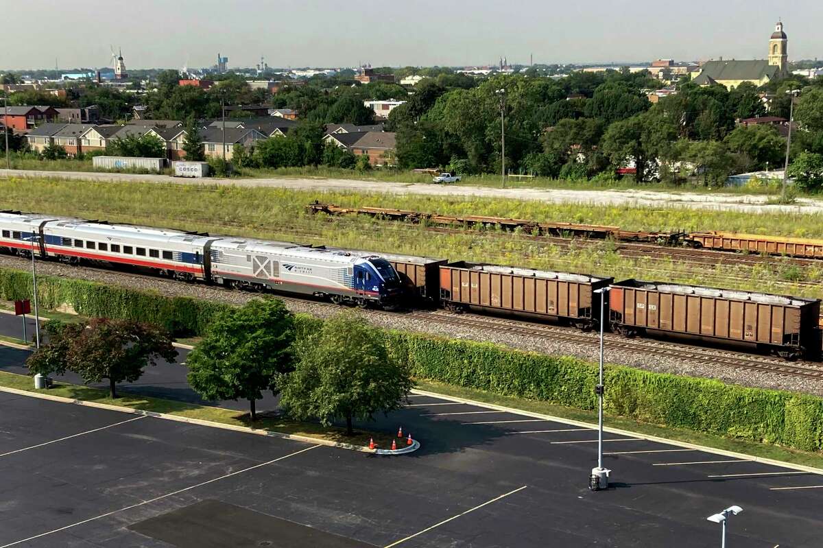 An Amtrak passenger train and a freight train head northbound towards downtown Chicago Wednesday, Sept. 14, 2022, in Chicago. Business and government officials are preparing for a potential nationwide rail strike at the end of this week while talks carry on between the largest U.S. freight railroads and their unions.
