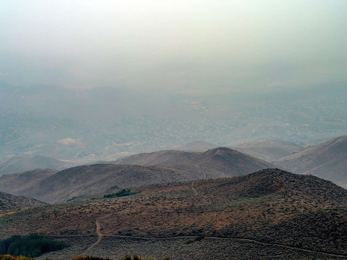 A file photo of a smoky landscape from the mountains overlooking Reno, Nev. Smoke from the Mosquito Fire prompted health officials to issue an emergency and shut down schools.?