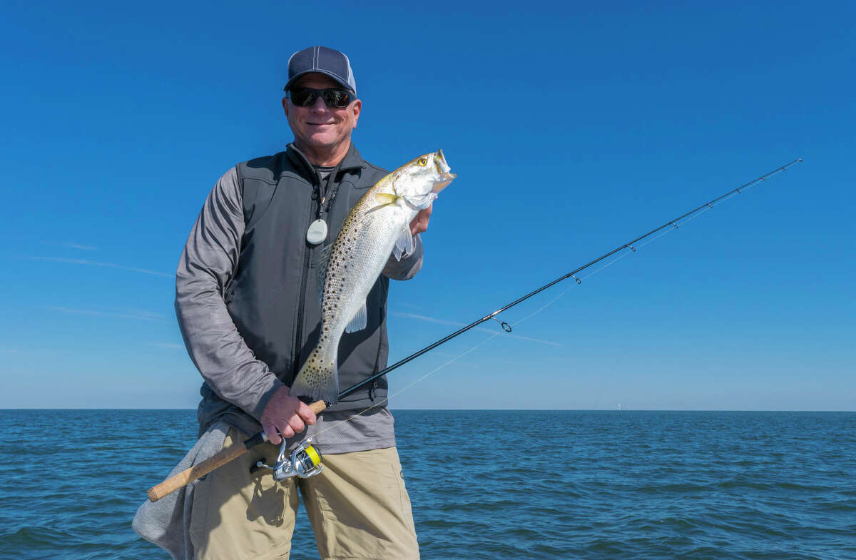 A fisherman holding a large speckled sea trout.  Here's a list of the top five fish anglers go after along the southeast Texas Coast. 
