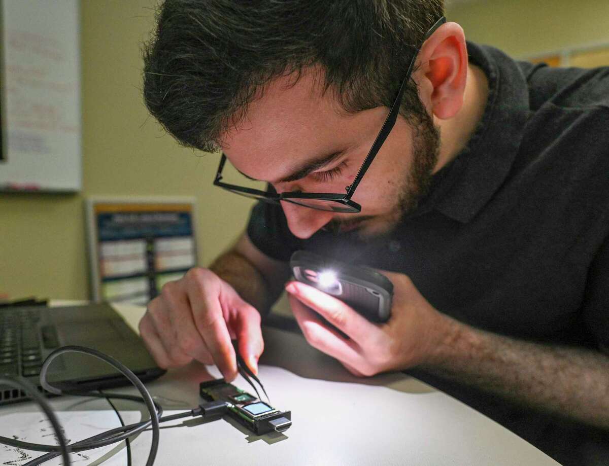 University of Texas at San Antonio student Jacob Rahimi extracts data from a memory stick in the school’s Internet of Things Security and Forensics Laboratory.
