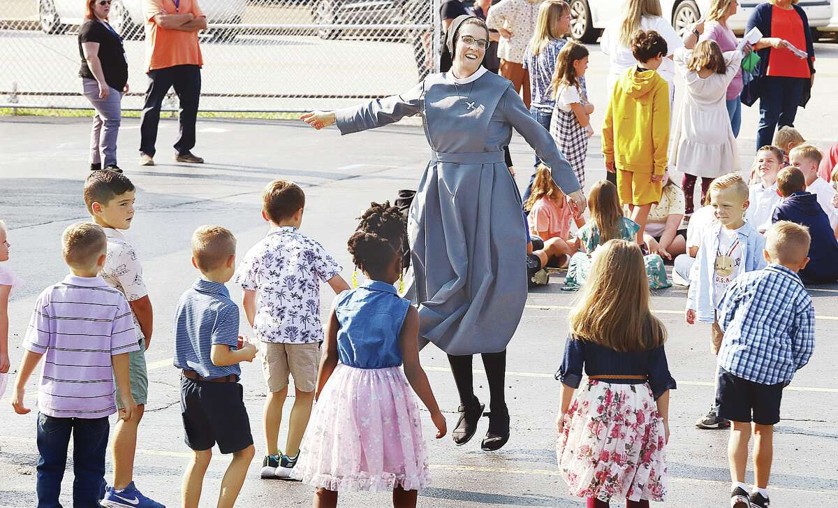 John Badman|The Telegraph A nun at St. Mary's Catholic School in Alton showed students how to make the most out of an evacuation caused by a gas leak. Students and staff were evacuated Wednesday morning for about an hour after a truck struck a gas line near the school's entrance. 