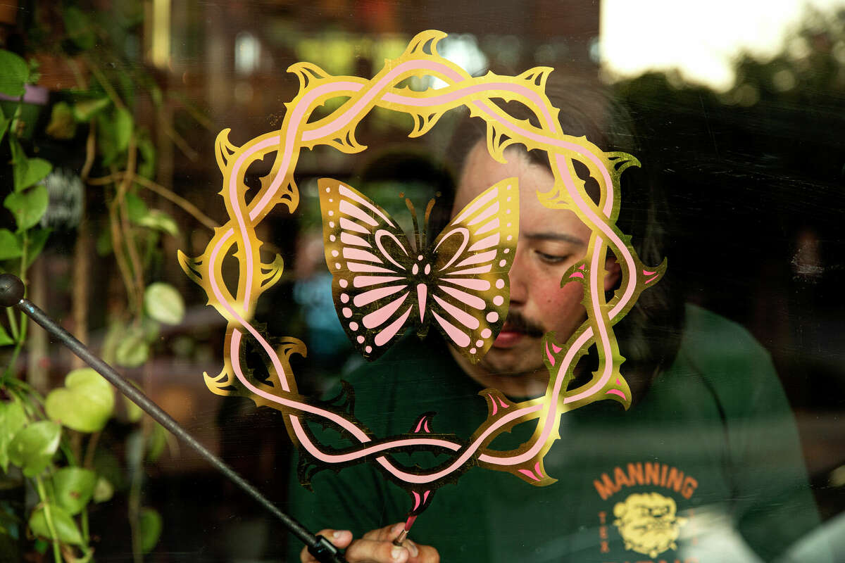 Manning also creates gold-leaf signs for businesses, like East Austin's Communion Tattoo.